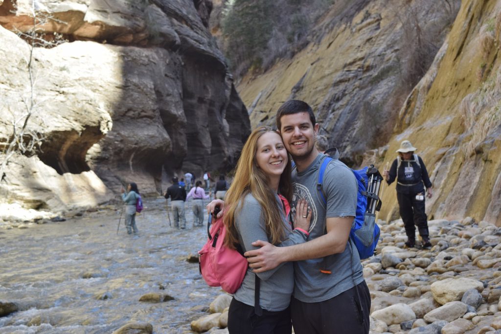 Brandon and Erin from Traveling Atlas in the Narrows in Zion National Park.