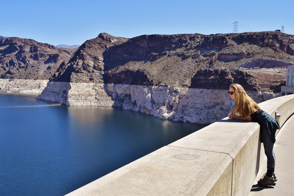 Erin leaning over the wall at the Hoover Dam.